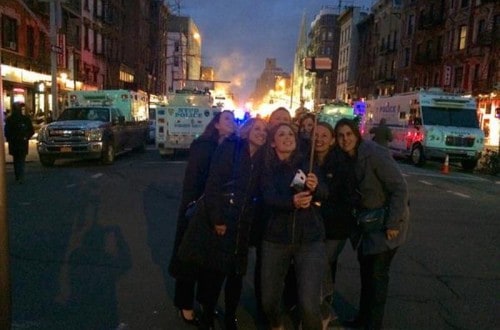 Women Take Selfie While Buildings Burn Behind Them In NYC