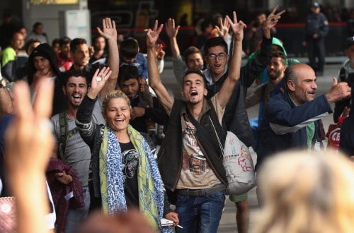 People Welcome Refugees With Applause And Gifts In Munich