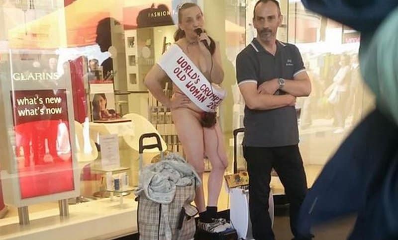 Scantily Clad Woman Glues Herself To Department Store In Bizarre Protest